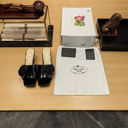 Prada 26s Open Toe Mules 45mm In Black Patent Calfskin With Rosette